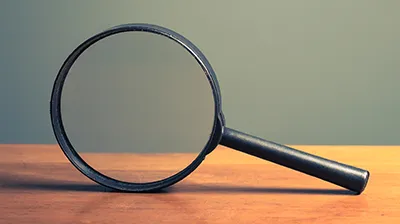 Magnifying glass on a table representing focus