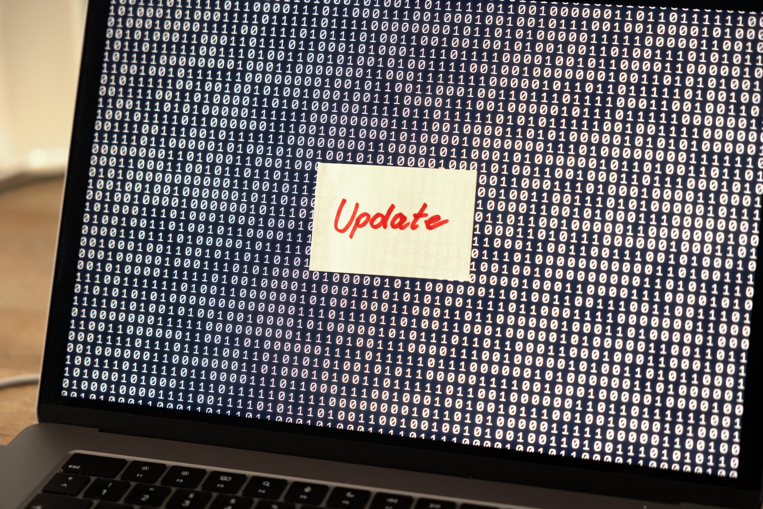 Computer software updates, note on the screen of a laptop.